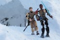 Star Wars LEGO action figures of Finn and Rey leaving real snow cave. Royalty Free Stock Photo