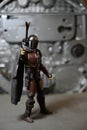 Star Wars The Mandalorian character Din Djarin pointing a blaster Royalty Free Stock Photo