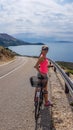 Stara Baska - Girl on a bike with a sea view Royalty Free Stock Photo