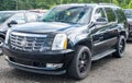 Starbrick, Pennsylvania, USA August 13, 2023 A used, black Cadillac Escalade SUV for sale at a dealership