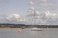 Starcross, devon: sailing boat with orange bouy. clouds