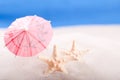 Starfish on the beach under an umbrella Royalty Free Stock Photo