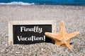 Starfish and chalkboard with the text finally vacation