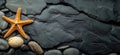 Starfish on dark slate background with pebbles, textured surface, marine elements, coastal decor, copy space for text Royalty Free Stock Photo