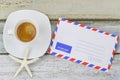 Starfish on Espresso coffee next to blank classic air mail envelope Royalty Free Stock Photo
