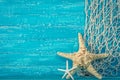 Starfish and fishing net on blue Royalty Free Stock Photo