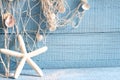 Starfish and fishing net on blue boards Royalty Free Stock Photo