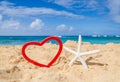 Starfish with heart shape on the sandy beach