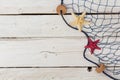 Starfish, marine network and rope on the old board