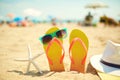 Starfish near flip flops and sunglasses on beach Royalty Free Stock Photo