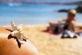 Starfish and person relaxing on the beach