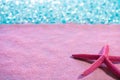 Starfish in pink sand beach and tropical sea Royalty Free Stock Photo