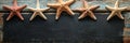 Starfish on Rustic Wooden Board with Copy Space Five starfish arranged on a weathered wooden surface creating a nautical Royalty Free Stock Photo