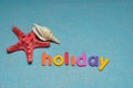 A starfish and a sea shell displayed with the word holiday