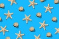 Starfish and sea shell pattern on blue. Summer minimalistic background. Top view, flat lay Royalty Free Stock Photo