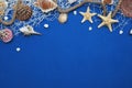 Starfish, Shell, Stones, Rope and Net Against a Blue Background with Copy Space. Summer Holliday. Nautical, Marrine concept.