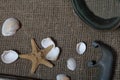 Starfish, shells and a mask with a snorkel for scuba diving. They lie on a rough linen fabric Royalty Free Stock Photo