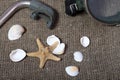 Starfish, shells and a mask with a snorkel for scuba diving. They lie on a rough linen fabric Royalty Free Stock Photo