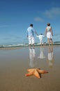 Starfish and tranquil family on the beach