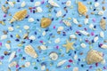 starfish and various multicolored seashells on blue wooden background