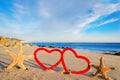 Starfishes with hearts on the sandy beach Royalty Free Stock Photo