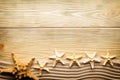 Starfishes, sand and wooden table