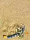 Starfishes and swimming goggles on sand Royalty Free Stock Photo