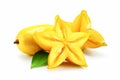 Starfruit, carambola with green leaves isolated on white background.