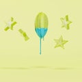 Starfruit dripping in blue paint and floating pieces of starfruit on pastel yellow background Royalty Free Stock Photo