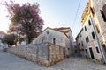 STARI GRAD, CROATIA - AUGUST 2019 Old Stone Houses and trees with pink flowers in Stari Grad on Hvar Island 1508 Royalty Free Stock Photo