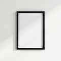 A stark black frame mounted on a whitewashed wall , interior, modern design, room Royalty Free Stock Photo