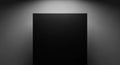 A solid black square with soft spotlight illumination against a dark gray gradient background Royalty Free Stock Photo