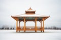 stark gazebo against a gray winter sky