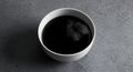 Minimalist black liquid in white bowl on concrete Royalty Free Stock Photo