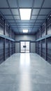 Stark view of an empty prison cell block corridor with rows of closed doors and a secure gate Royalty Free Stock Photo