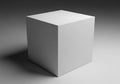 A stark white rectangular prism casting a subtle shadow on a textured gray surface Royalty Free Stock Photo