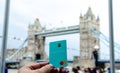 Starling Bank card hold in hand and London Tower Bridge at the blurred background