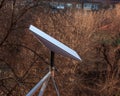 Starlink satellite dish, an internet constellation operated by SpaceX, is installed on the wall of an apartment building. View Royalty Free Stock Photo