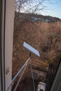 Starlink satellite dish, an internet constellation operated by SpaceX, is installed on the wall of an apartment building. View Royalty Free Stock Photo