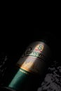 Staropramen beer on black watery background with highlights on waves. Tomsk Russia 2022