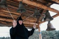 Nun bell-ringer in orthodox church