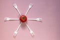 Starring from forks with tomato in the middle. Royalty Free Stock Photo