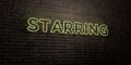 STARRING -Realistic Neon Sign on Brick Wall background - 3D rendered royalty free stock image