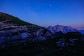 Starry morning sky spans above the rocky mountains in the serene Julian Alps. Royalty Free Stock Photo