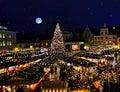 Christmas tree night starry sky in Tallinn market place panorama , full moonlight city town Hall Square Illuminated blurred lig