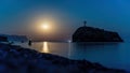 Starry night with a full moon over sea with rock in front. Cape Fiolent, Jasper beach rock of the holy phenomenon with a cross. Royalty Free Stock Photo