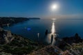 Starry night with a full moon over sea, yachts and rocks in front. Cape Fiolent, Orest and Pilad rocks on the background of the Royalty Free Stock Photo