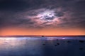 Starry night at sea , blue pink cloudy sky sunset light reflection on water wave reflection on horizon boat tropical skyline