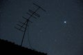 Starry night sky with antenna and Jupiter - symbol of alien comm