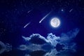 Starry night sky with full moon rising above serene sea, shooting stars or comets in dark sky Royalty Free Stock Photo